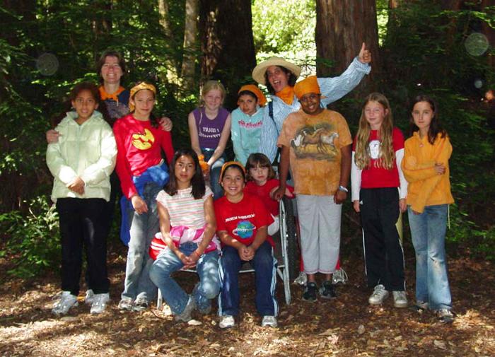 Thalia with her Girl Scout troop in the woods.